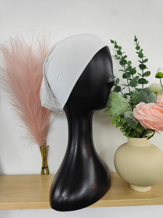 Bamboo Jersey Hijab Bond in White, exclusively sold by Hikmah Boutique. This hijab bond blends comfort and style, making it an essential piece of hijab cap for any hijabi's modest clothing collection.