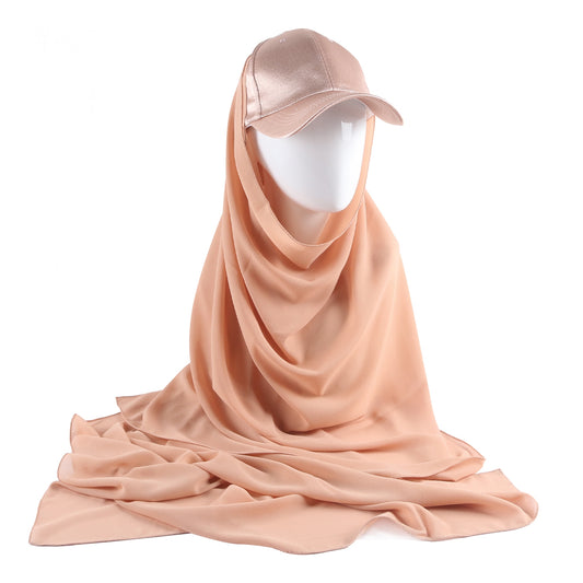 Immerse yourself in the serene beauty of the Coral Sand Satin Baseball Cap with Chiffon Hijab, a captivating creation from Hikmah Boutique. This unique accessory effortlessly blends the relaxed charm of a classic baseball cap with the luxurious texture of satin and the gentle flow of chiffon hijab.