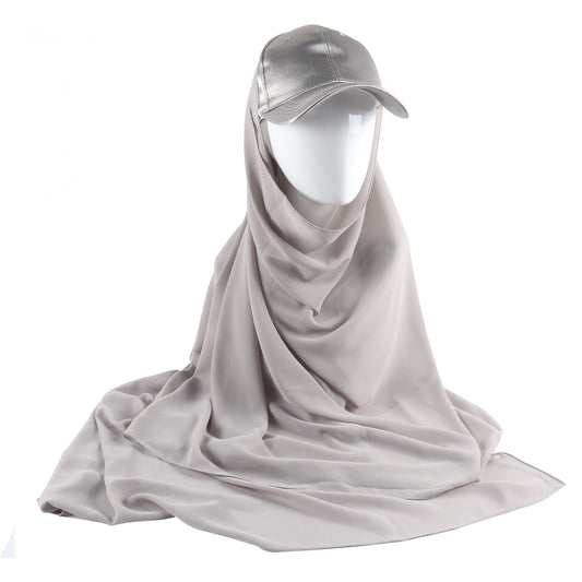 Discover the allure of understated sophistication with Hikmah Boutique's Silver Grey Satin Baseball Cap with Chiffon Hijab. This striking accessory seamlessly marries the timeless charm of a classic baseball cap with the lustrous elegance of satin, coupled with the grace and flow of chiffon hijab.