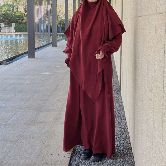 Indulge in the allure of timeless sophistication with our exclusive Maroon Crepe Crinkle Abaya with Khimar, a masterpiece curated for the modern woman by Hikmah Boutique. Drenched in the rich and regal hue of maroon, this ensemble seamlessly blends modesty with contemporary style, making it a must-have addition to your wardrobe.