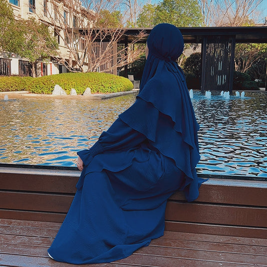 Indulge in the perfect union of style and modesty with our Navy Crepe Crinkle Abaya with Double Layer Khimar Set, an exclusive offering available only at Hikmah Boutique. Immerse yourself in the rich navy tones, enveloped in the soft embrace of premium crepe fabric, adorned with modest designs.