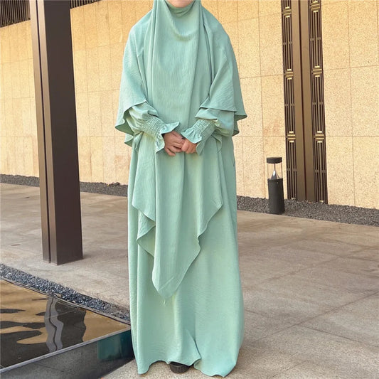 Shop Modest Clothing with our Dusty Green Crepe Crinkle Abaya with Double Layer Khimar Set – Exclusive Modesty at Hikmah Boutique. Immerse yourself in the serene charm of our Dusty Green Crepe Crinkle Abaya with Double Layer Khimar Set, a timeless modesty exclusively available at Hikmah Boutique.