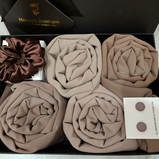 Indulge in the luxury of Hikmah Boutique's Chiffon Hijab Gift Box - The Tan Set. This gift box is the perfect style of sophistication, style and elegance. This set includes 4 premium quality chiffon hijabs in the most versatile colors of light taupe, chocolate, Desert Palm and Almandine, to suit every mood. Perfect Gift!