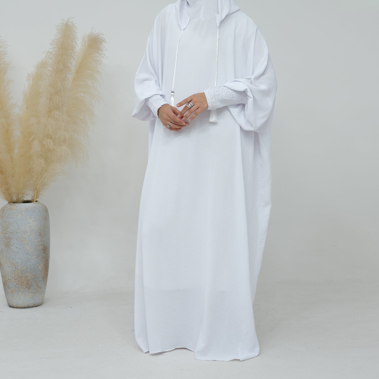 Discover purity and modesty with our White Hooded Jilbab Abaya, a symbol of grace and elegance exclusively available at Hikmah Boutique. Meticulously crafted, this refined garment is designed to elevate your modest wardrobe with timeless sophistication.
