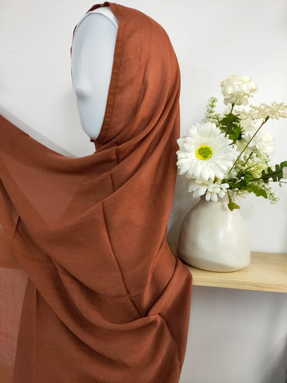 Introducing our sophisticated Modal Hijab in Dark Caramel, a timeless choice for the discerning modest woman, at Hikmah Boutique! Crafted with precision from premium modal fabric, cherished for its gentle touch and breathability, this modal hijab promises enduring comfort and style. Based in Australia, Deliver Worldwide.