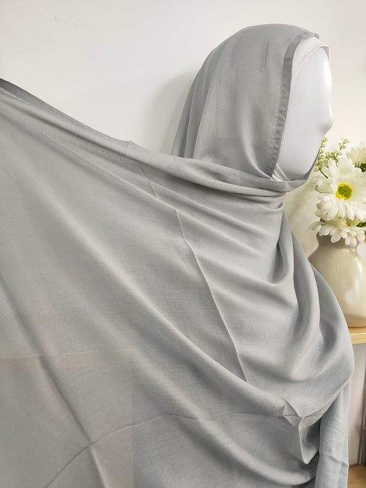 Introducing our sophisticated Silver Grey Modal Hijab, a timeless choice for the discerning modest woman, available at Hikmah Boutique! Crafted with precision from modal fabric, cherished for its gentle touch and breathability, this modal hijab promises enduring comfort and style. Based in Australia, Deliver Worldwide.