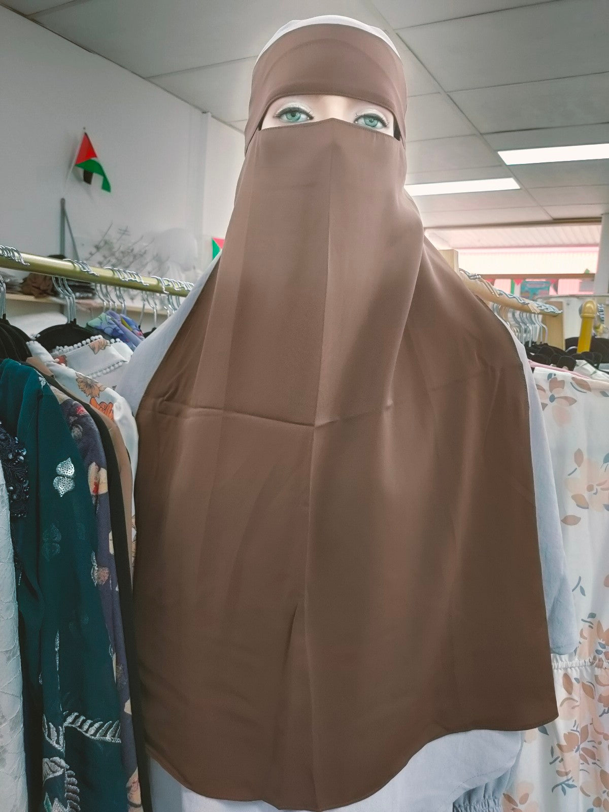 Indulge in the subtle charm of the Hikmah Boutique Single Layer Niqab in Coffee. This finely crafted niqab epitomizes the essence of modest clothing, offering both coverage and comfort in a classic design.