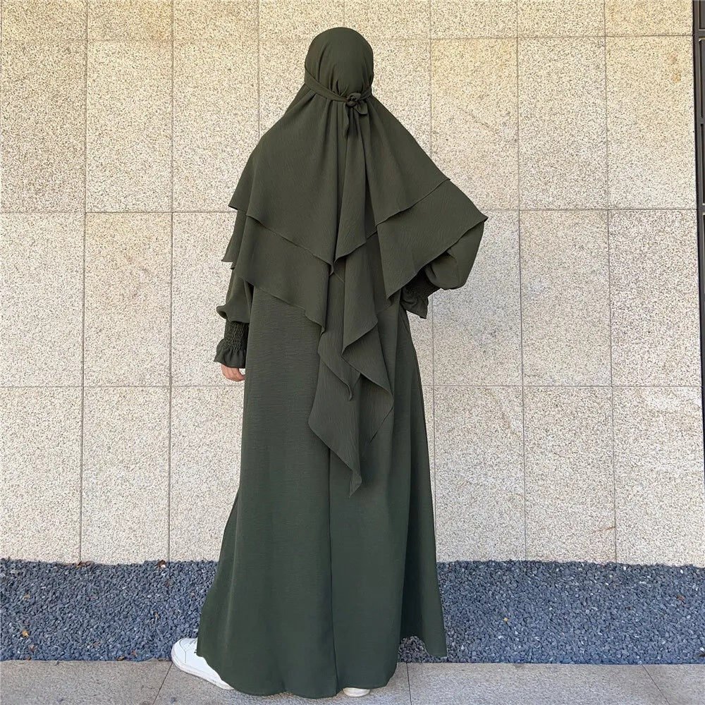 Shop Modest Clothing with our Olive Green Crepe Crinkle Abaya with Double Layer Khimar Set – Exclusive Modesty at Hikmah Boutique Elevate your wardrobe with the understated elegance of our Olive Green Crepe Crinkle Abaya with Double Layer Khimar Set, a timeless modesty available at Hikmah Boutique.
