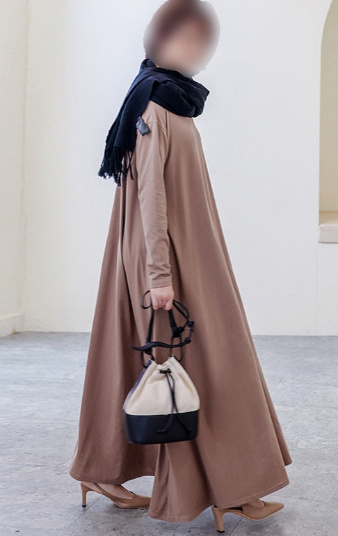 Introducing the Khaki Abaya Dress, a stunning addition to your wardrobe that is perfect for any occasion. Made with high-quality fabric, this abaya is durable, comfortable, and designed to last. Featuring a beautiful khaki color, this abaya is a classic choice that will never go out of style. The crew neck adds a touch of elegance.