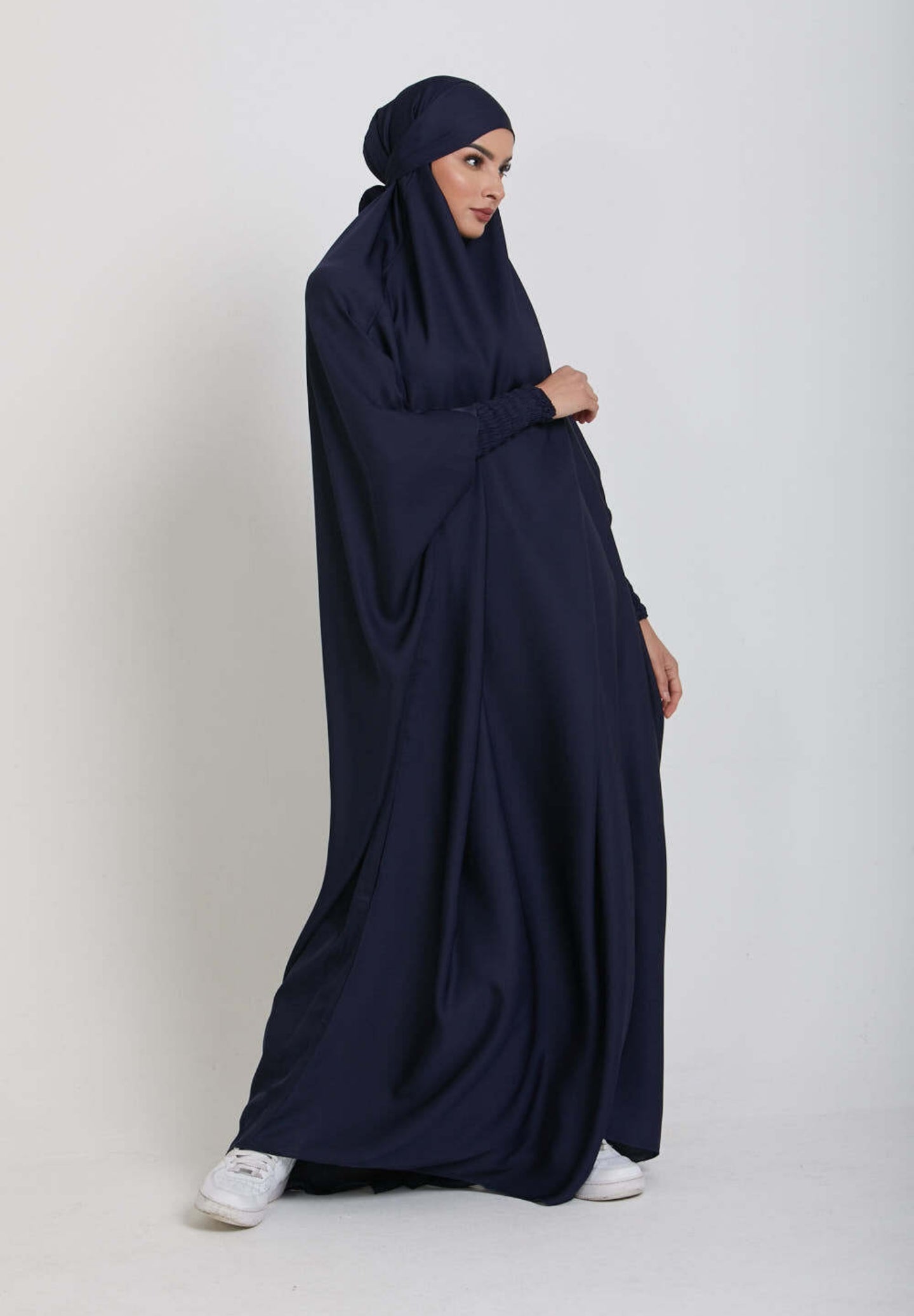 Dive into divine tranquility with our Navy One Piece Tie-Up Jilbab. This exclusive Islamic garment seamlessly blends modesty with contemporary allure, creating a captivating fusion of grace and comfort for your sacred moments of devotion.