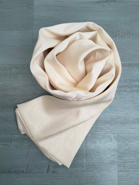 Discover elegance with our Cream Satin Hijab. Crafted from premium satin, exuding sophistication. These Textured Satin Hijabs are Perfect for formal occasions or daily wear. Discover the best satin hijabs online, perfect for special occasions. Premium quality and trendy designs at Hikmah Boutique.