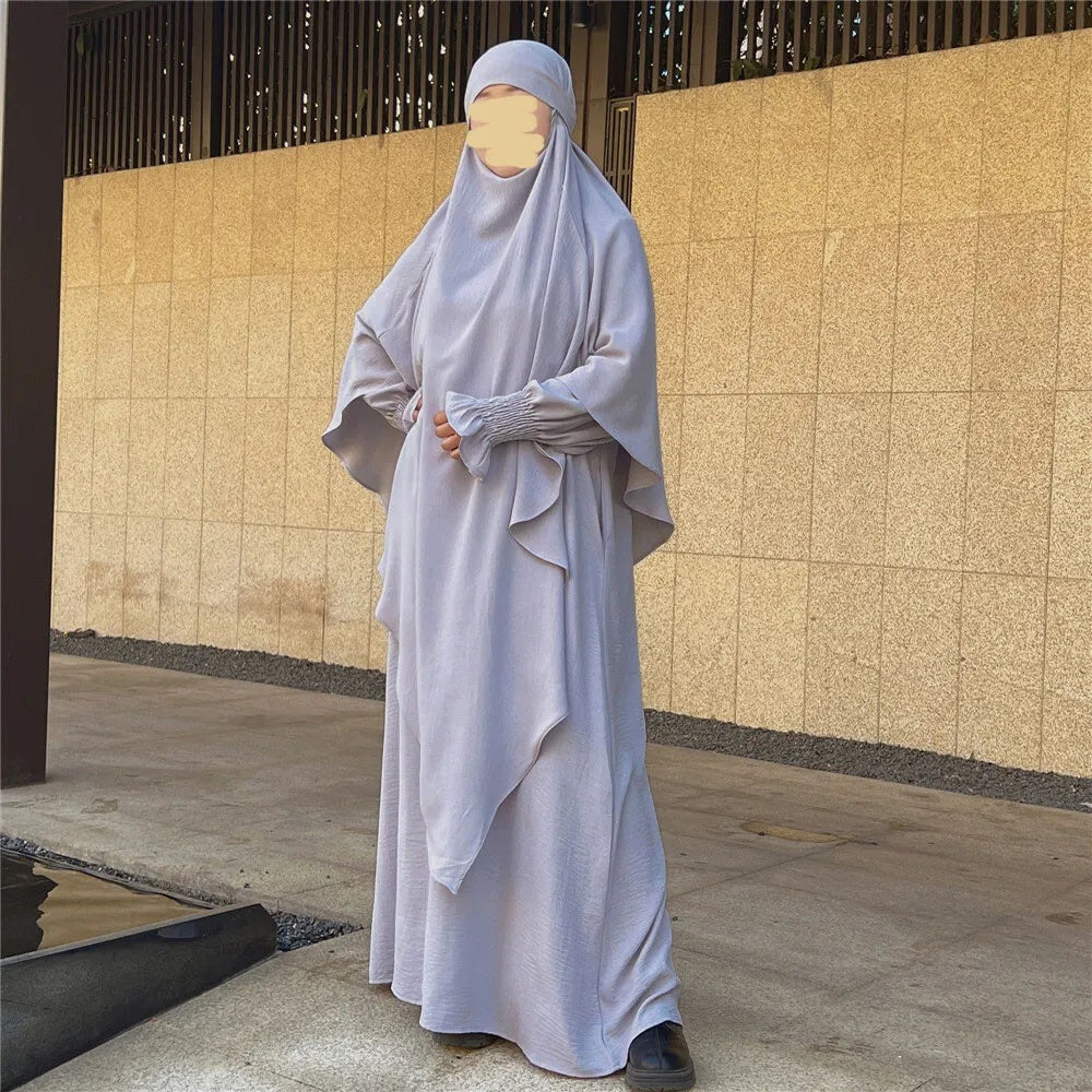 Indulge is an understated elegance of our Silver Grey Crepe Crinkle Abaya with Double Layer Khimar Set, a symbol of modesty and sophistication exclusively available at Hikmah Boutique. The modest design of silver grey offers an ensemble that seamlessly blends tradition and contemporary style with refined grace.
