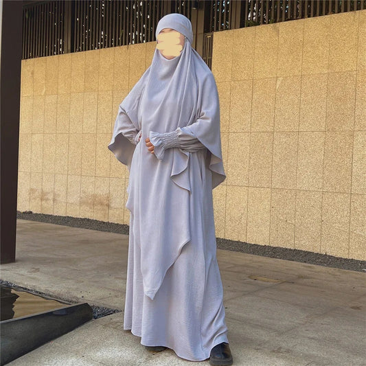 Indulge is an understated elegance of our Silver Grey Crepe Crinkle Abaya with Double Layer Khimar Set, a symbol of modesty and sophistication exclusively available at Hikmah Boutique. The modest design of silver grey offers an ensemble that seamlessly blends tradition and contemporary style with refined grace.