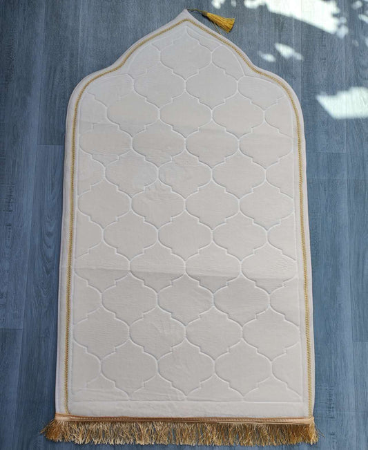 Experience serenity and comfort with our White Cream Padded Prayer Mat by Hikmah Boutique. This plush velvet mat offers optimal cushioning for a tranquil prayer experience. Adult size of 110cm x 65cm. Perfect for home, office, mosque, or travel. Elevate your prayers and helps you attain Khushu in your salah.