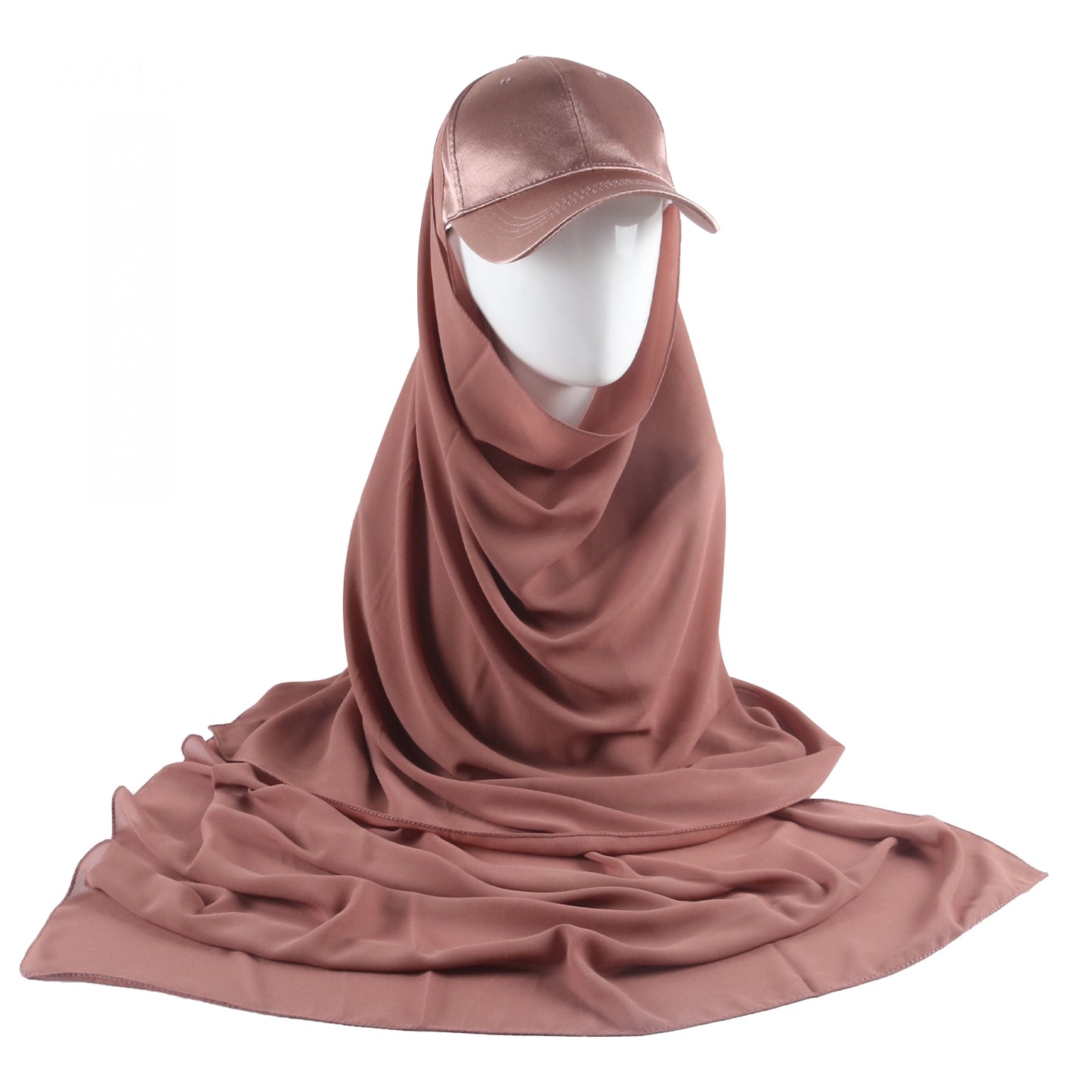 Immerse yourself in the warm and rich sophistication of the Mocha Satin Baseball Cap with Chiffon Hijab, a luxurious creation from Hikmah Boutique. This exquisite accessory seamlessly blends the casual allure of a classic baseball cap with the opulent feel of satin and the graceful flow of chiffon hijab. 