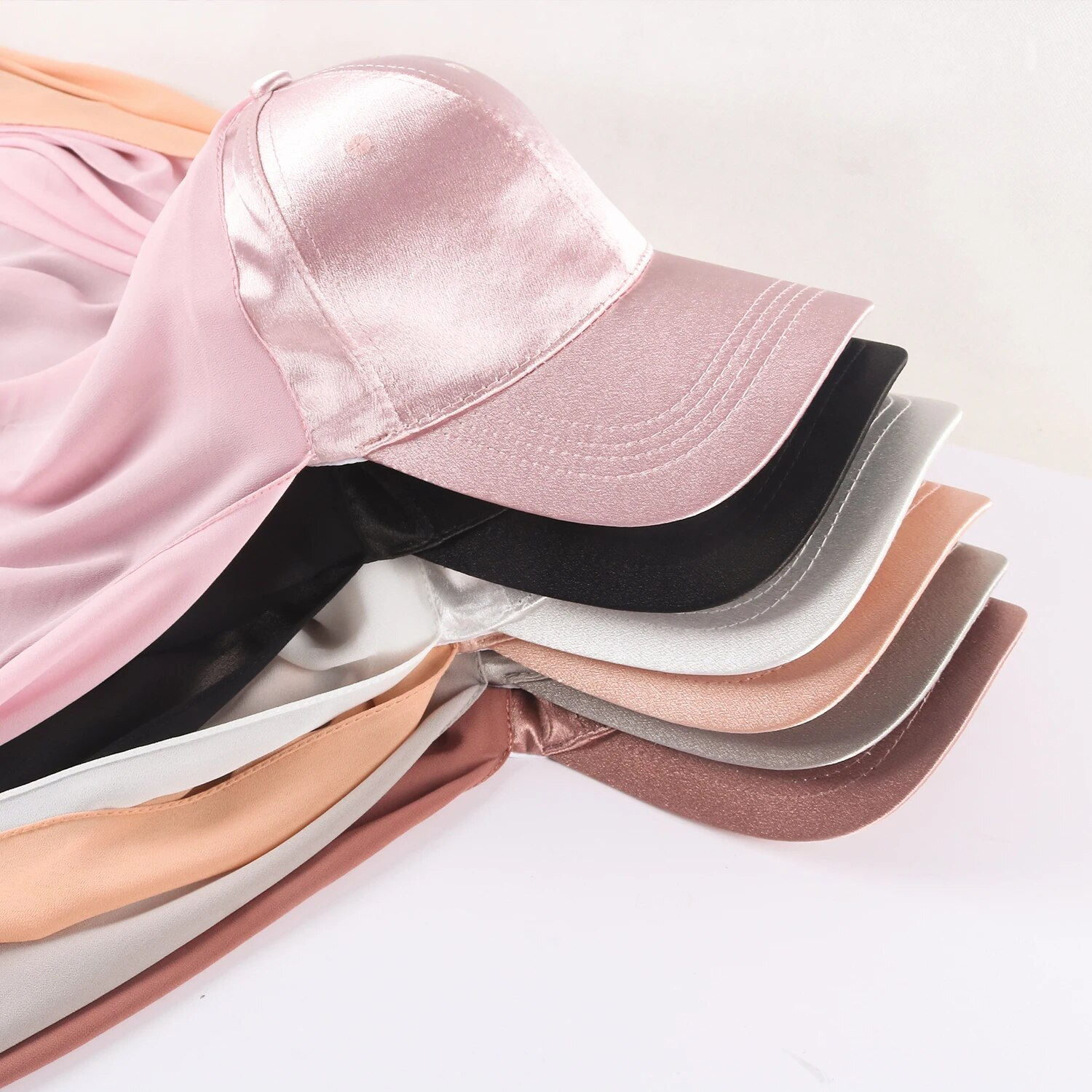 Black Satin Baseball Cap with Chiffon Hijab available at Hikmah Boutique. This unique and stylish piece seamlessly combines the casual flair of a classic baseball cap with the elegance of a chiffon hijab, creating a fashion-forward accessory that caters to the diverse needs of the modern Muslim woman. 
