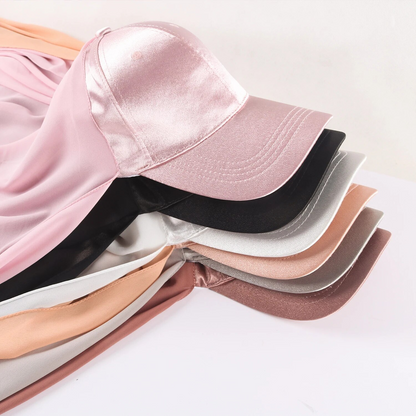 Immerse yourself in the warm and rich sophistication of the Mocha Satin Baseball Cap with Chiffon Hijab, a luxurious creation from Hikmah Boutique. This exquisite accessory seamlessly blends the casual allure of a classic baseball cap with the opulent feel of satin and the graceful flow of chiffon hijab. 