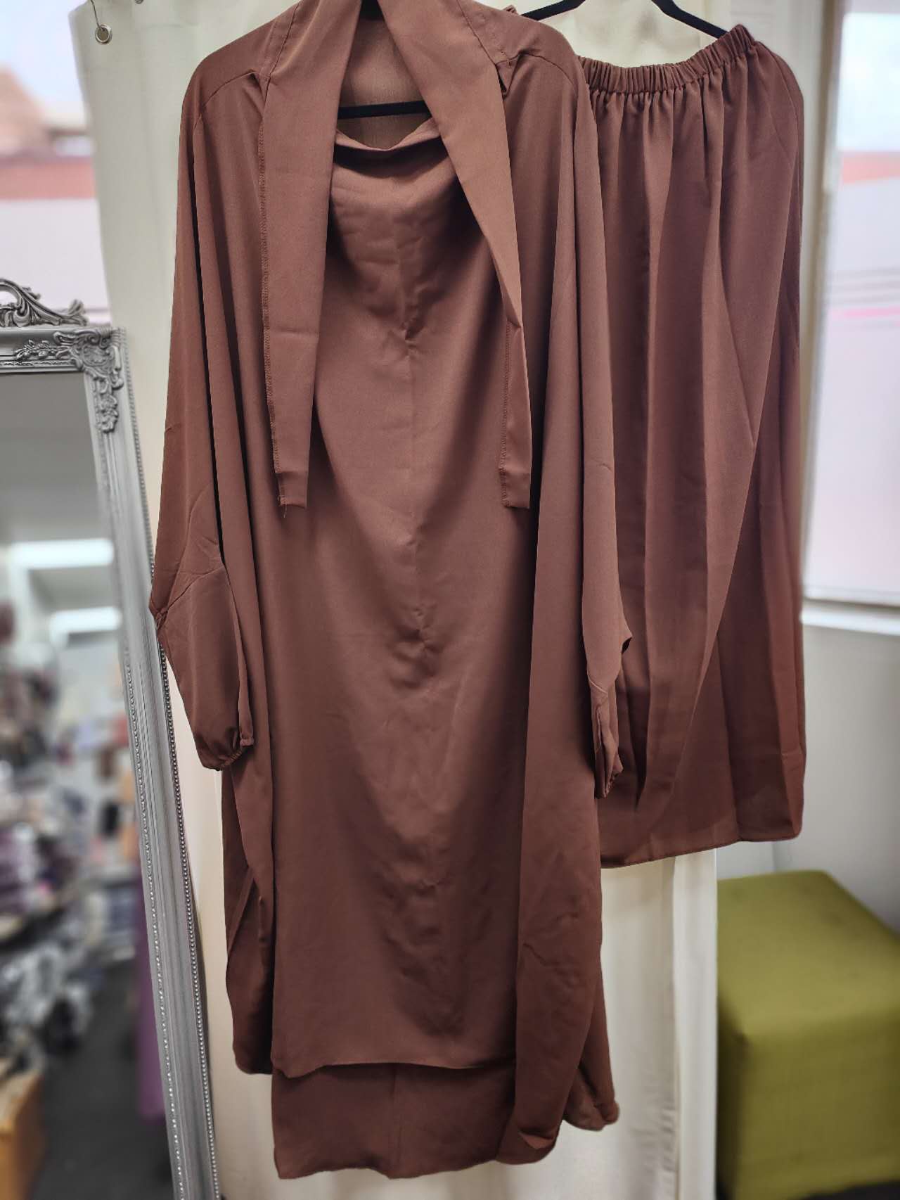 Discover timeless elegance with our Coffee Two-Piece French Jilbab. Hikmah Boutique brings you a blend of style and devotion, featuring a tie-up design, extra-long length for prayer, and versatile coffee hue. Shop now for affordable and stylish modest wear tailored exclusively for you.