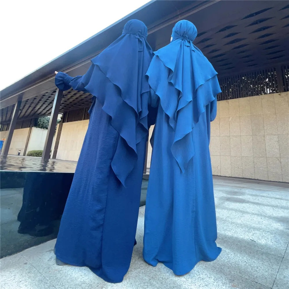 Indulge in the perfect union of style and modesty with our Navy Crepe Crinkle Abaya with Double Layer Khimar Set, an exclusive offering available only at Hikmah Boutique. Immerse yourself in the rich navy tones, enveloped in the soft embrace of premium crepe fabric, adorned with modest designs.