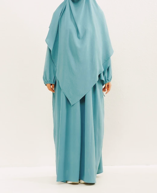 Introducing our stunning Crepe Double Layer Khimar in Aqua, available exclusively at Hikmah Boutique. Crafted with meticulous attention to detail, this khimar is meticulously designed to elevate your modest fashion game to new heights. 
