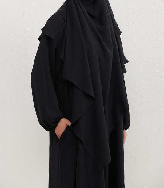 Introducing our exquisite Crepe Double Layer Khimar in Black, exclusively available at Hikmah Boutique. Crafted with meticulous attention to detail, this double layer khimar is designed to elevate your modest fashion game to new heights.