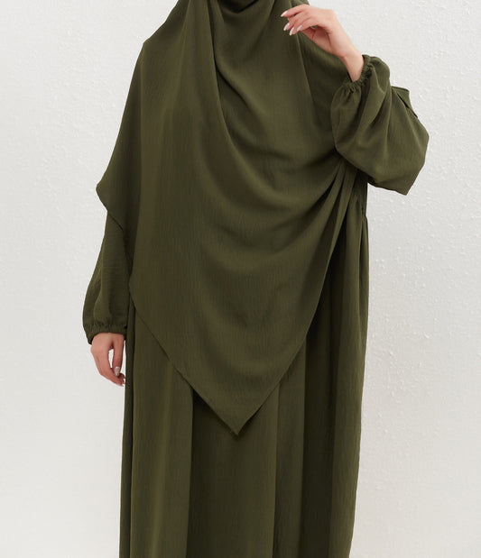 Introducing our exquisite Crepe Double Layer Khimar in Olive Green, a symbol of modesty and grace, exclusively available at Hikmah Boutique. Crafted with meticulous attention to detail, this khimar is meticulously designed to uphold Islamic principles of modest dressing. 