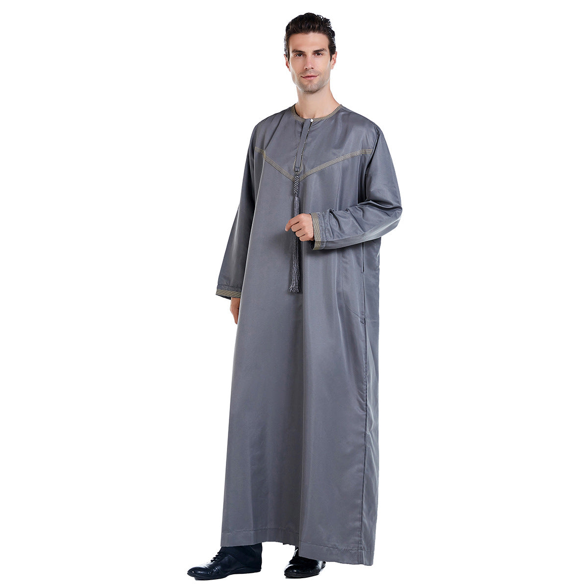 Introducing the Emirati Men's Thobe in Grey, a captivating and versatile garment that effortlessly combines traditional Islamic elegance with Modest Clothing style. This meticulously crafted thobe is designed to enhance your appearance and offer unrivaled comfort, making it a perfect choice for any occasion.