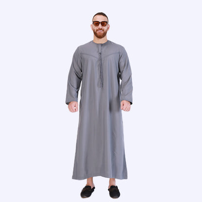 Introducing the Emirati Men's Thobe in Slate Grey, a timeless and sophisticated piece of traditional Islamic clothing crafted to perfection. This meticulously designed thobe combines the rich heritage of Emirati fashion with contemporary style, offering a remarkable choice for modest men. Shop online at Hikmah Boutique