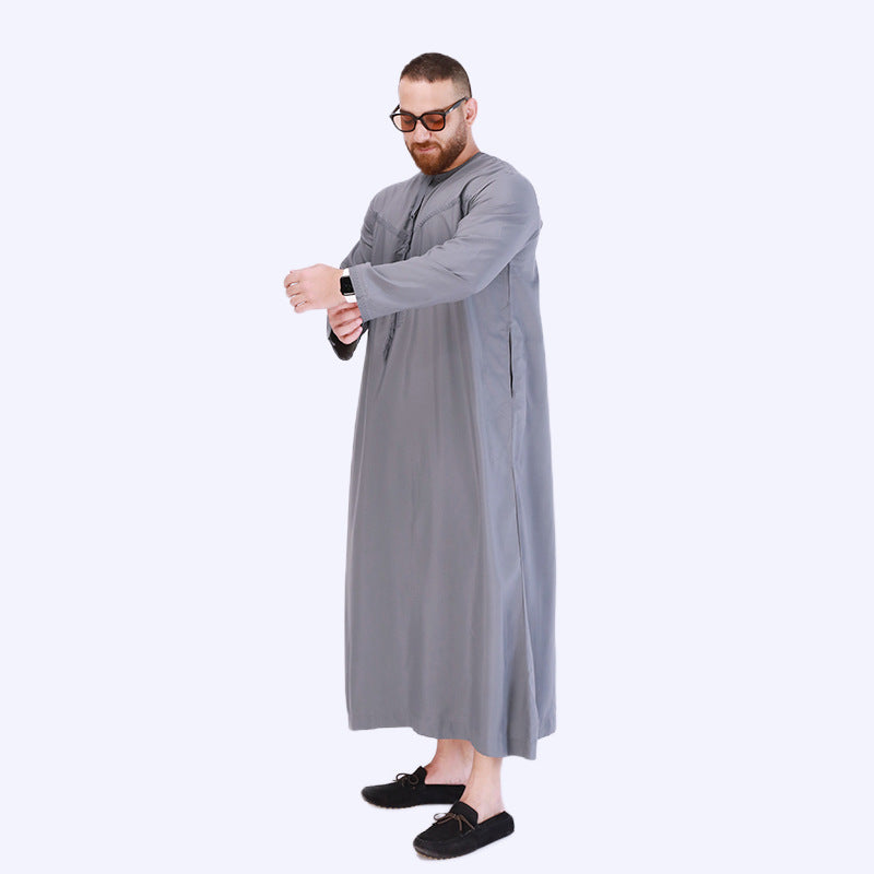 Introducing the Emirati Men's Thobe in Slate Grey, a timeless and sophisticated piece of traditional Islamic clothing crafted to perfection. This meticulously designed thobe combines the rich heritage of Emirati fashion with contemporary style, offering a remarkable choice for modest men. Shop online at Hikmah Boutique
