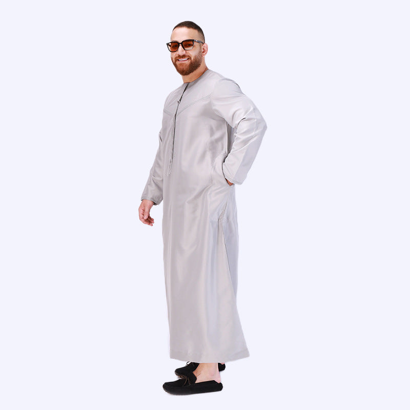 Introducing the Emirati Men's Thobe in Light Grey, a captivating and versatile garment that effortlessly combines traditional elegance with contemporary style. This meticulously crafted thobe is designed to enhance your appearance and offer comfort, making it a perfect choice for any occasion. Hikmah Boutique exclusive