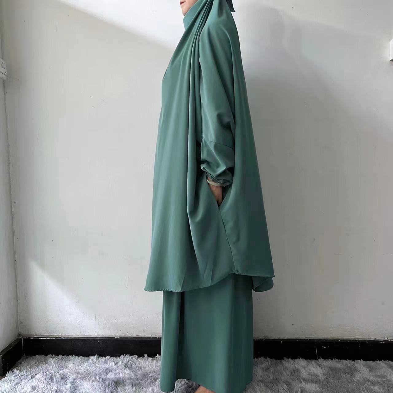 Introducing the Dusty Forest Green French Jilbab Prayer Set from Hikmah Boutique, a perfect combination of modesty and style. This one-size jilbab and skirt set features cuff sleeves and is made from premium Nida fabric, ensuring breathability and comfort.