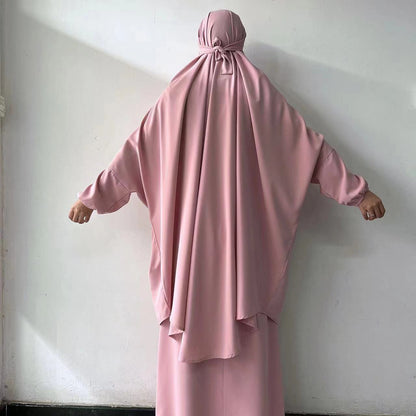 Add a touch of delicate charm to your prayer wardrobe with our Dusty Pink French Jilbab Prayer Set from Hikmah Boutique. This one-size jilbab and skirt set with cuff sleeves is made from luxurious Nida fabric, offering breathability and comfort.