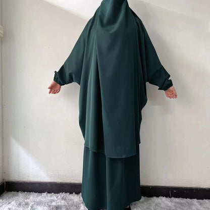 Step into vibrant elegance with our Emerald Green French Jilbab Prayer Set from Hikmah Boutique. This one-size jilbab and skirt set with cuff sleeves is made from high-quality Nida Fabric, ensuring breathability and comfort.