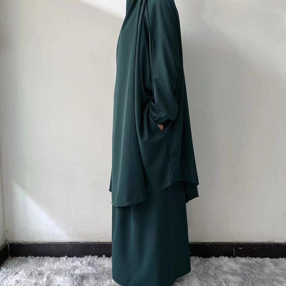 Step into vibrant elegance with our Emerald Green French Jilbab Prayer Set from Hikmah Boutique. This one-size jilbab and skirt set with cuff sleeves is made from high-quality Nida Fabric, ensuring breathability and comfort.