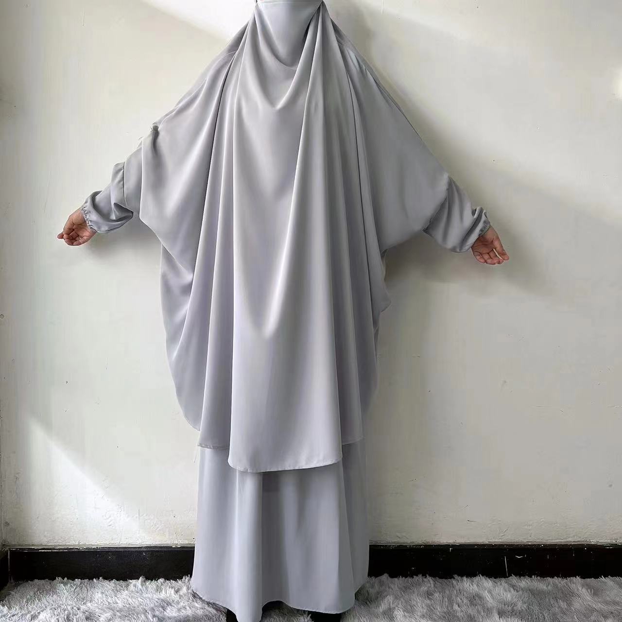 Experience the subtle elegance of our Light Grey French Jilbab Prayer Set, exclusively at Hikmah Boutique. This one-size jilbab and skirt set, featuring cuff sleeves, is crafted from soft, breathable Nida fabric for ultimate comfort.