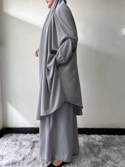 Experience the subtle elegance of our Light Grey French Jilbab Prayer Set, exclusively at Hikmah Boutique. This one-size jilbab and skirt set, featuring cuff sleeves, is crafted from soft, breathable Nida fabric for ultimate comfort.