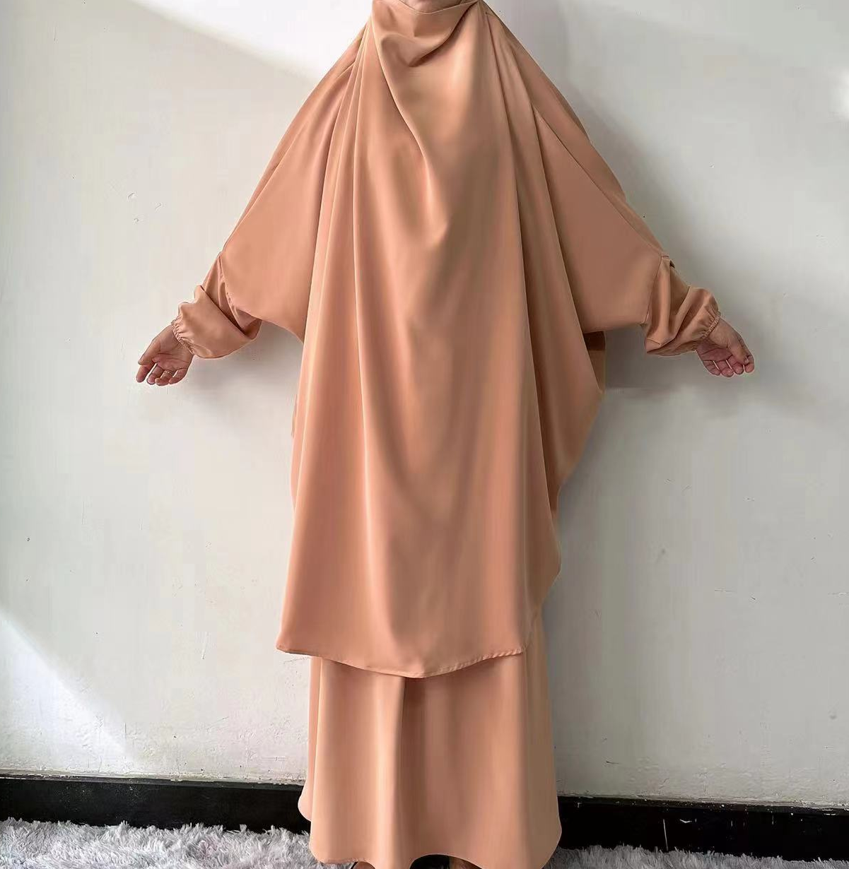 Step into refined elegance with our Teak Tan French Jilbab Prayer Set, exclusively at Hikmah Boutique. This one-size jilbab and skirt set, featuring cuff sleeves, is crafted from high-quality Nida fabric for maximum comfort and breathability.