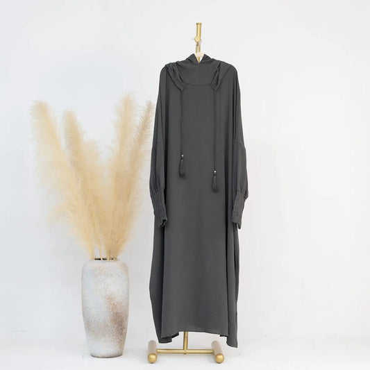 Introducing our Slate Grey Hooded Jilbab Abaya, a manifestation of sophistication and modesty exclusively offered at Hikmah Boutique. Crafted with meticulous care, this refined garment is designed to elevate your modest wardrobe with grace and poise.