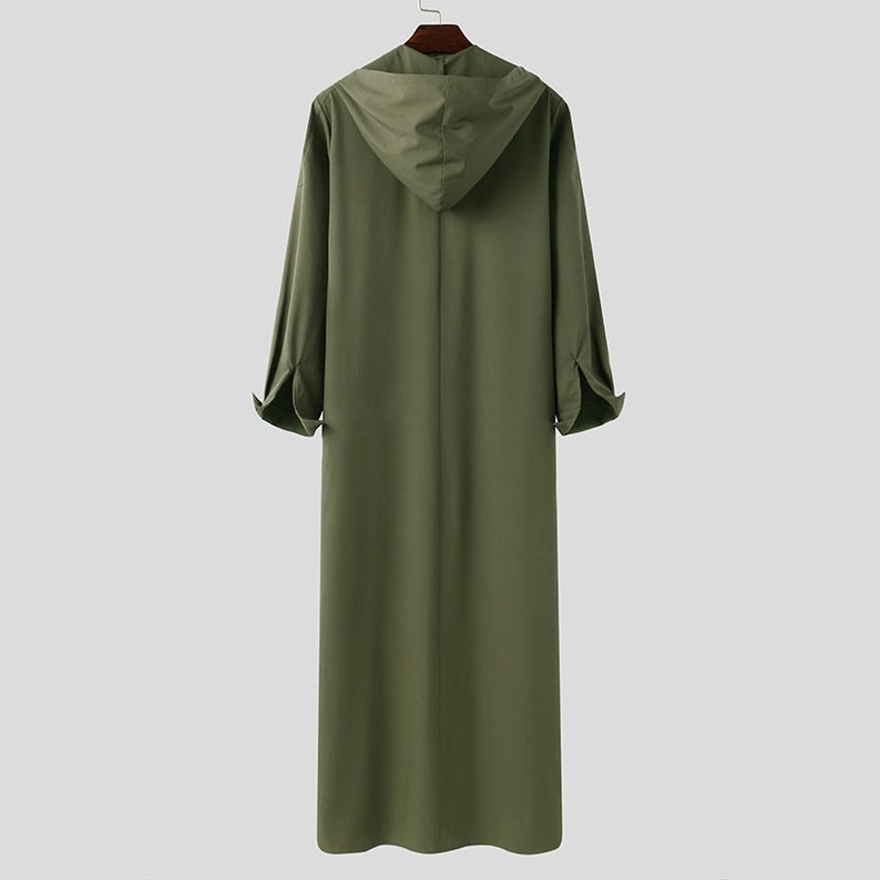 Discover our exclusive collection of hooded mens thobes in a captivating green color at Hikmah Boutique. Explore modern designs, tailored fits, and functional pockets. Elevate your style with fashionable and comfortable Islamic clothing for men. Shop now and embrace the elegance of Arabian attire. Shop at Hikmah Boutique