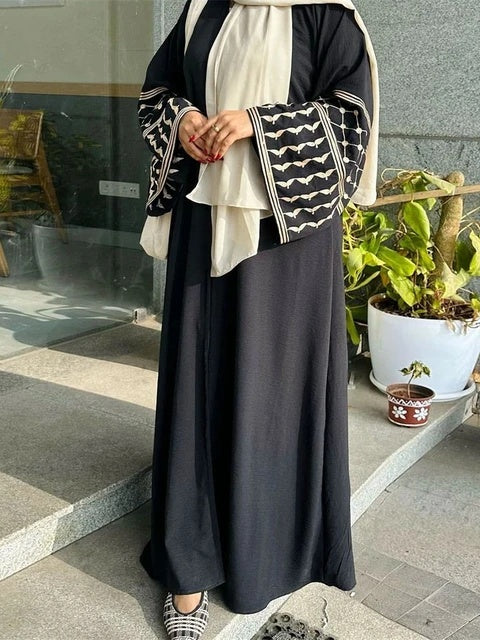 Elevate your style with the Keffiyeh Sleeve Abaya in Black. A powerful blend of tradition and modesty. Buy this symbolic abaya online at Hikmah Boutique today.