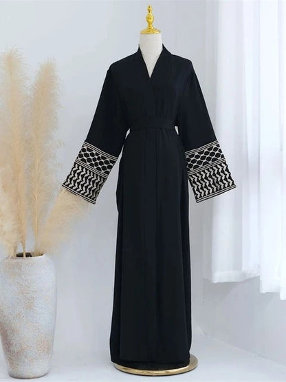 Elevate your style with the Keffiyeh Sleeve Abaya in Black. A powerful blend of tradition and modesty. Buy this symbolic abaya online at Hikmah Boutique today.