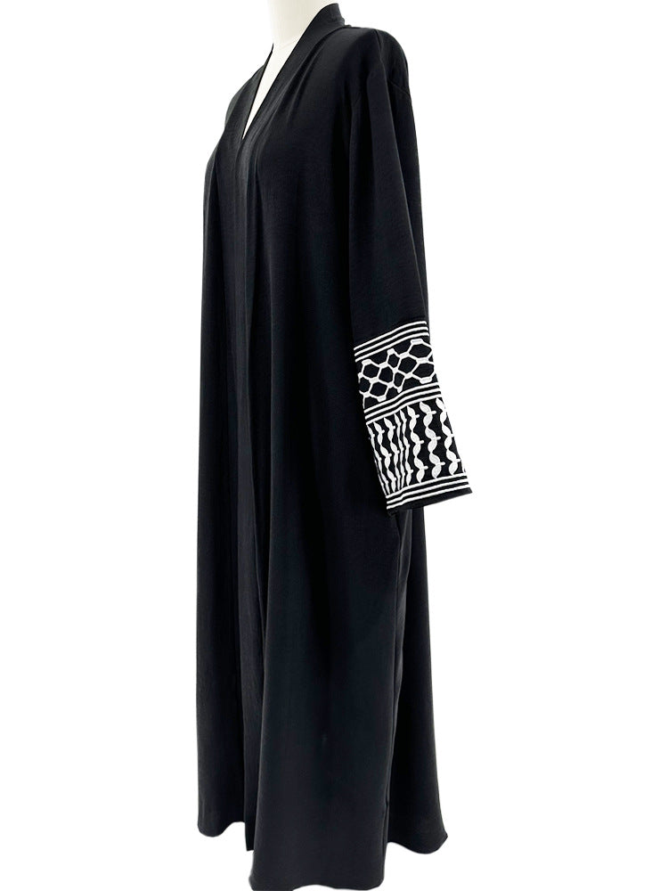 Elevate your style with the Keffiyeh Sleeve Abaya in Black. A powerful blend of tradition and modesty. Buy this symbolic abaya online at Hikmah Boutique today.