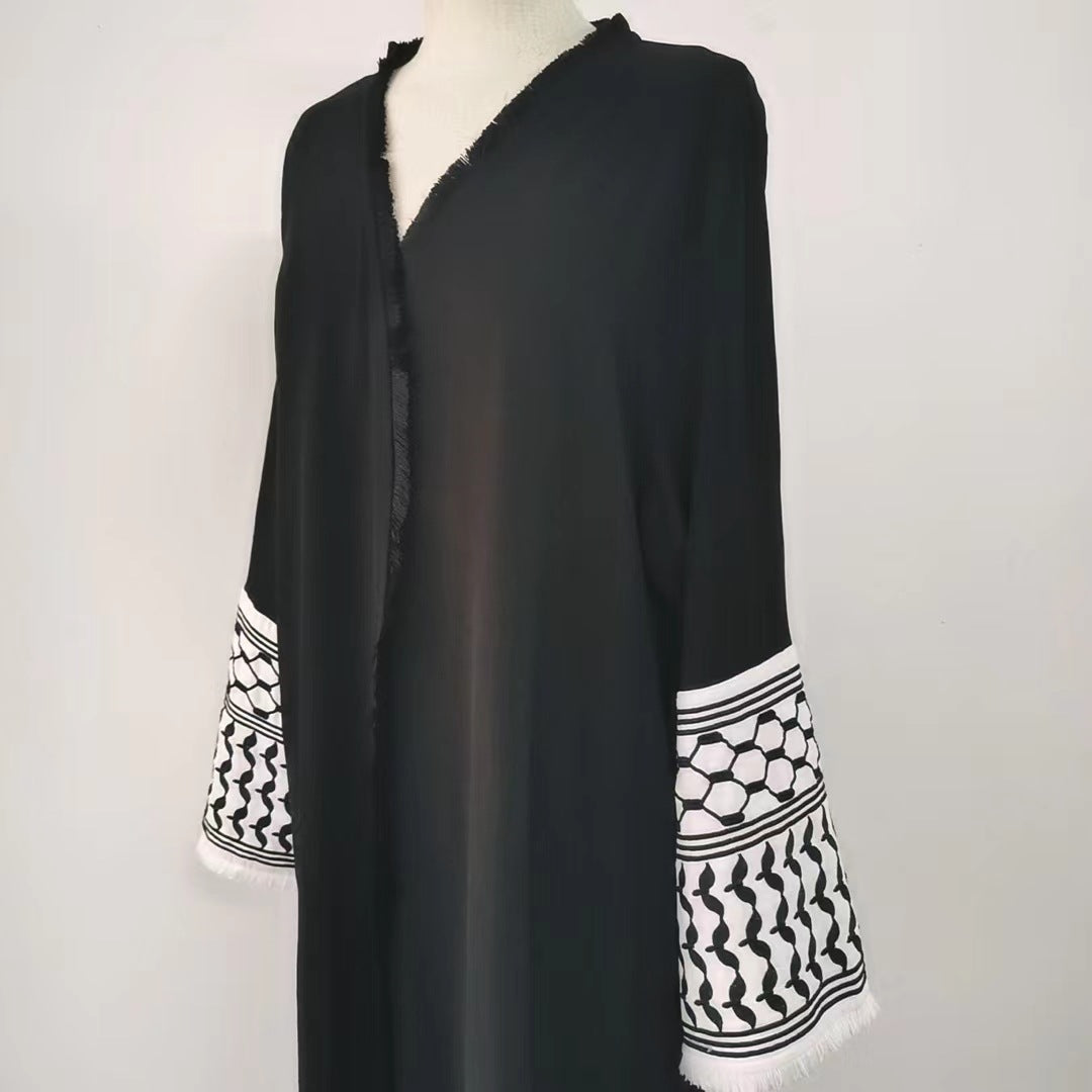 Make a bold statement with our stunning Black Keffiyeh Sleeve Open Abaya from Hikmah Boutique. A timeless piece that effortlessly combines style and modesty.