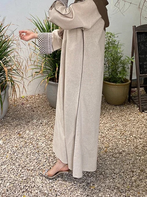 The Keffiyeh Sleeve Abaya in Light Khaki by Hikmah Boutique is more than just a modest garment; it's a symbol of solidarity with Palestine. This closed abaya features the traditional Keffiyeh pattern on the sleeves. Buy online Australia.