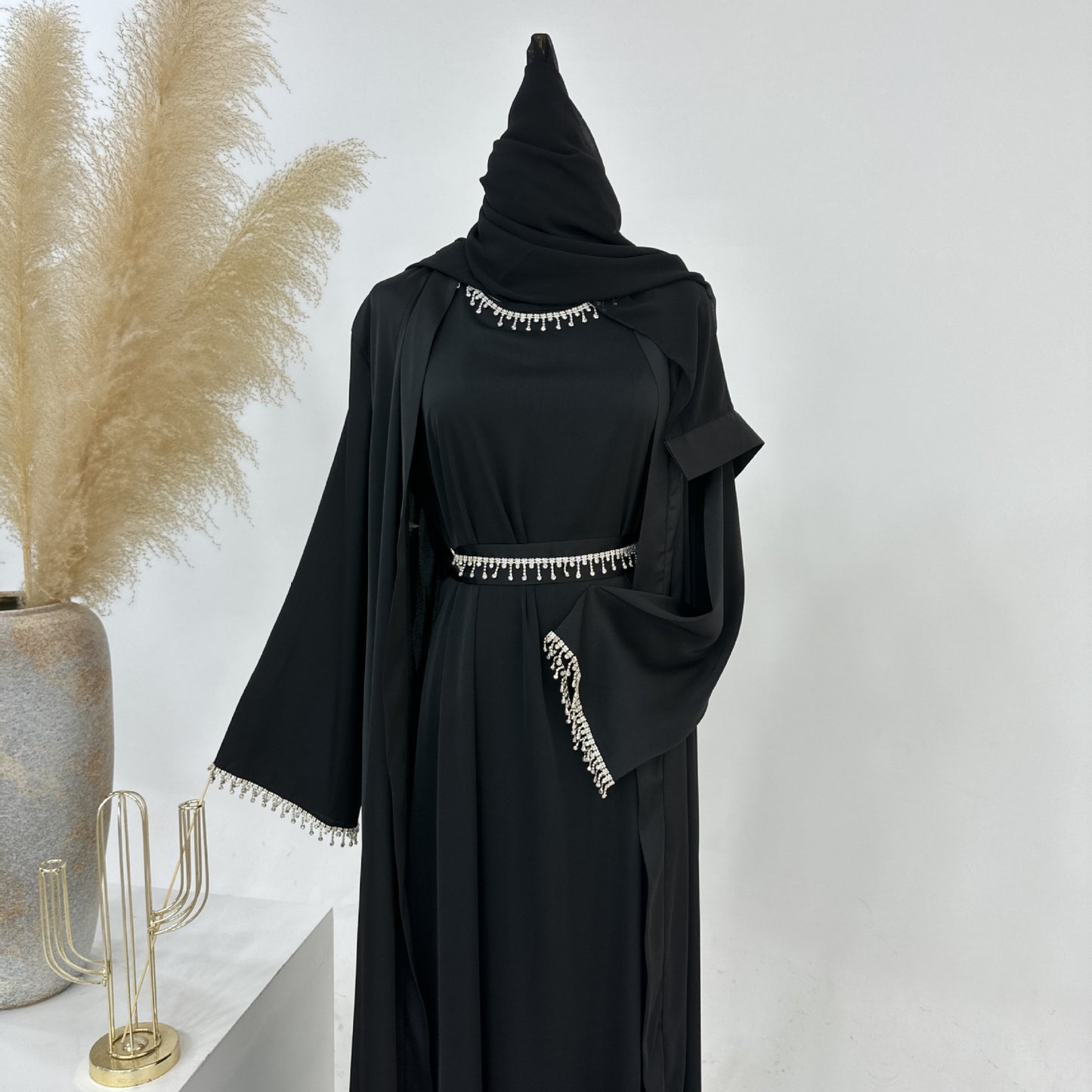Discover sophistication and grace with the Malika Abaya in Black, exclusively available at Hikmah Boutique. Crafted from luxurious Satin silk material, this timeless abaya provides comfort and modesty. Elevate your modest clothing with our versatile 4-piece abaya set, perfect for Eid, Wedding and all occasions.