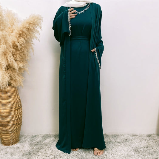 Introducing the Malika Abaya in Emerald Green, exclusively available at Hikmah Boutique. Crafted meticulously with luxurious Satin silk material, this exquisite abaya provides unparalleled comfort and opulence. The Malika Abaya in Emerald Green is a striking addition to your modest clothing wardrobe. 