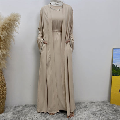 Introducing the Malika Abaya in Sandstone, exclusively available at Hikmah Boutique. Crafted meticulously with luxurious Satin silk material, this exquisite ensemble promises unparalleled comfort and opulence. The Malika Abaya in Sandstone is a versatile addition to your modest clothing wardrobe.