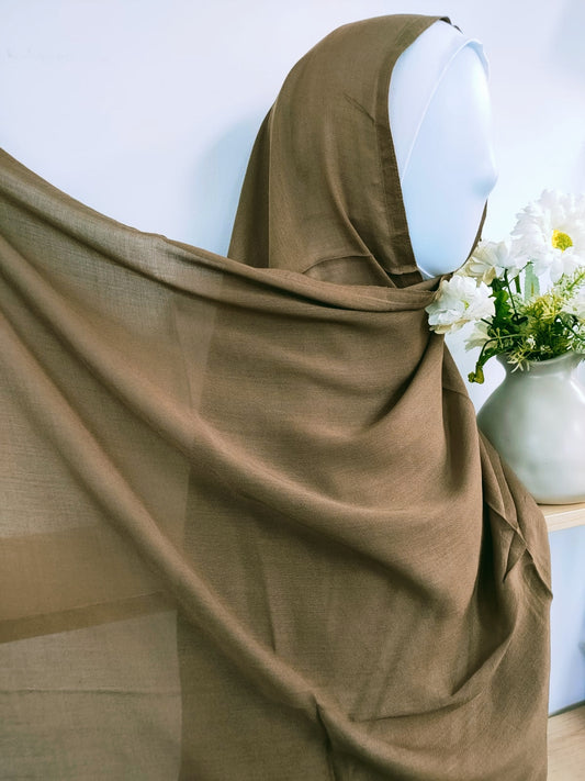 Shop now for our sophisticated Modal Hijab in Dark Khaki, a versatile staple for your hijab collection, available at Hikmah Boutique! Crafted with precision from premium modal fabric, renowned for its luxurious softness and breathability, this hijab ensures comfort and style all day. Based in Australia, Deliver Worldwide.