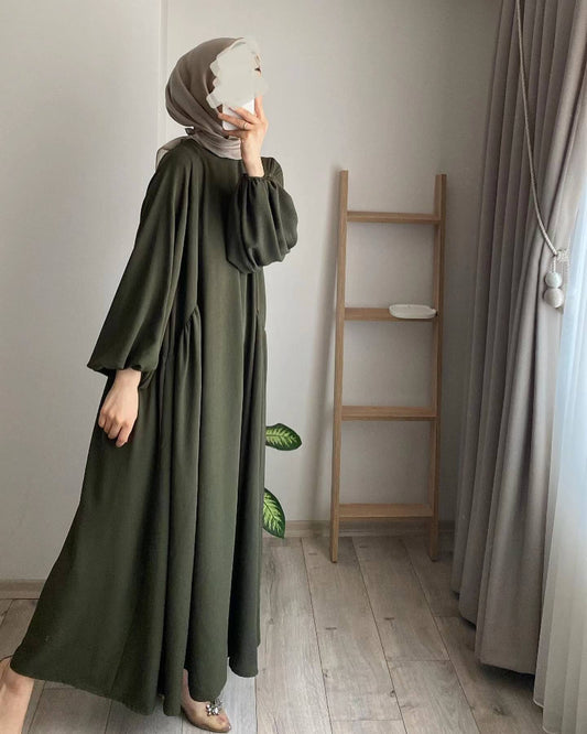 The Modest Crepe Abaya in Dark Olive is a modest wardrobe essential that effortlessly combines comfort and style. Visit our Hijab boutique to find the perfect modest fashion pieces.