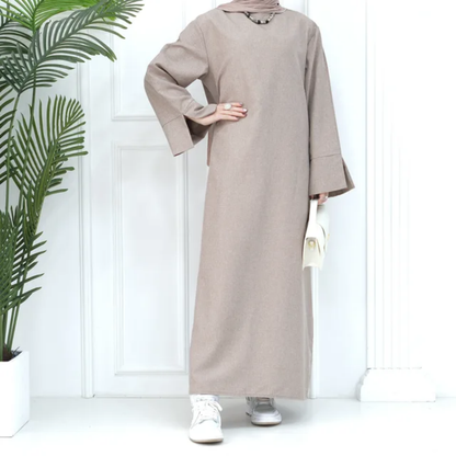 Shop the Modest Plain Abaya in Dusty Sandstone at Hikmah Boutique. Earthy tone, modest fit, and long sleeves. Available in all sizes at reasonable prices.